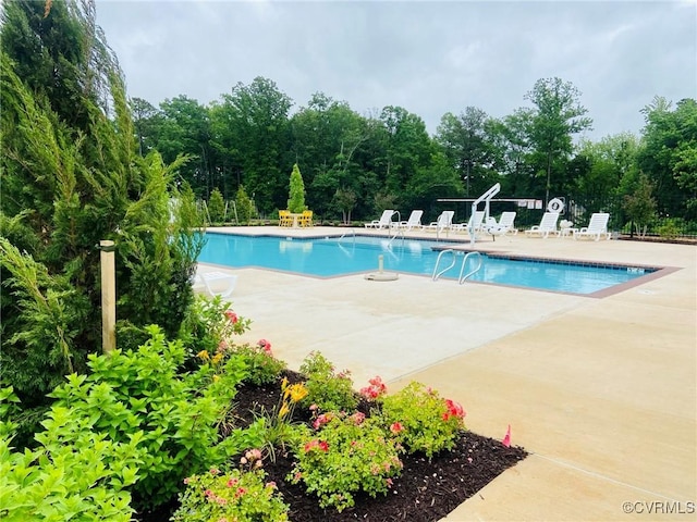 pool featuring fence and a patio area