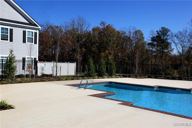 view of swimming pool with a fenced in pool, a patio, and fence