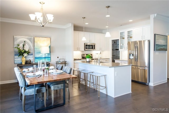 kitchen with dark wood finished floors, crown molding, glass insert cabinets, and appliances with stainless steel finishes