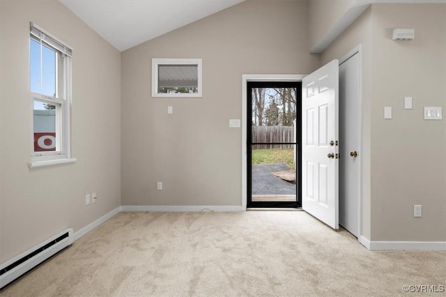 foyer entrance featuring a baseboard heating unit, plenty of natural light, carpet, and vaulted ceiling