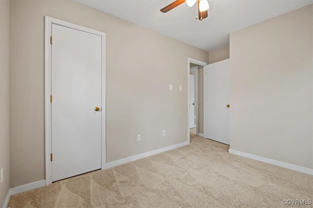 unfurnished bedroom featuring baseboards, carpet floors, and ceiling fan