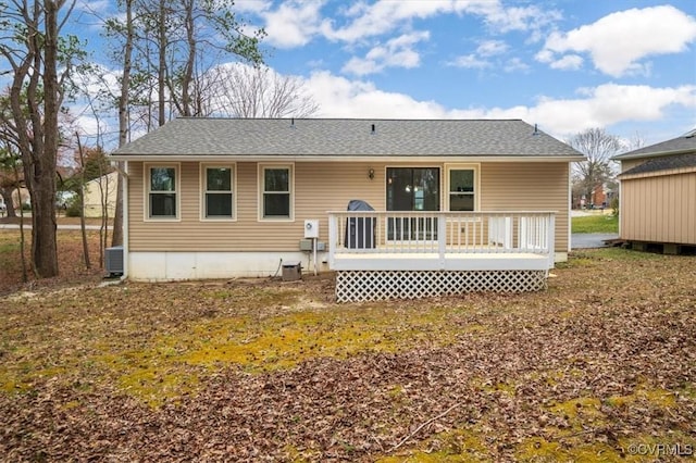 rear view of property with a deck, central AC, and a shingled roof