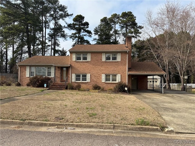 view of front of property featuring a front lawn, fence, concrete driveway, an attached carport, and a chimney