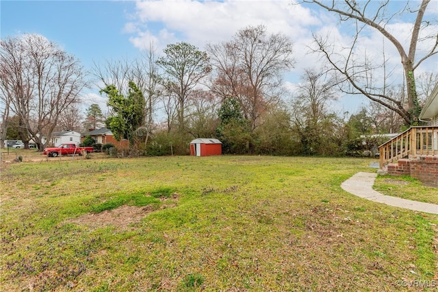 view of yard featuring an outbuilding and a shed