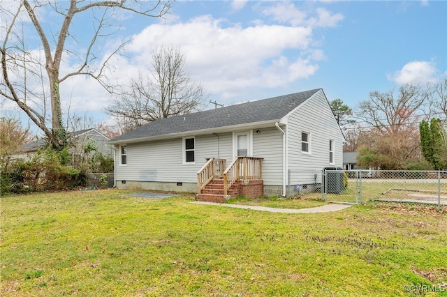 back of property featuring a shingled roof, fence, a lawn, crawl space, and a gate