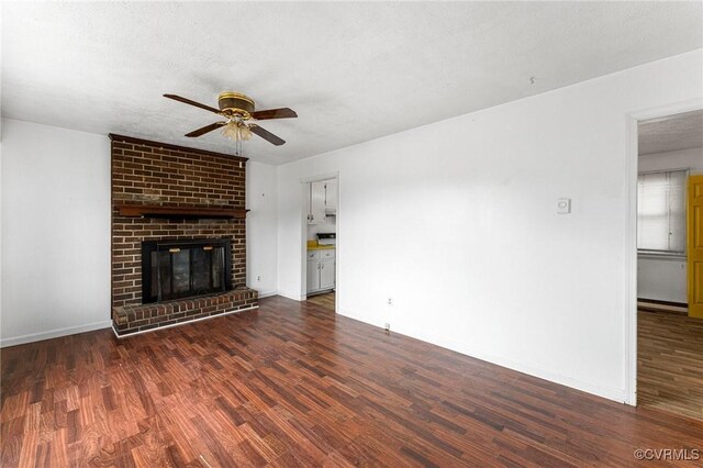 unfurnished living room with wood finished floors, a ceiling fan, baseboards, a baseboard radiator, and a textured ceiling