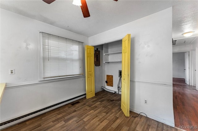 unfurnished bedroom with wood finished floors, a closet, a textured ceiling, a ceiling fan, and a baseboard radiator