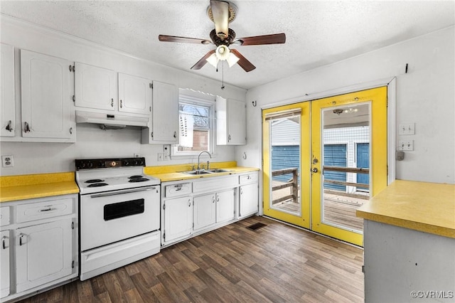 kitchen featuring a sink, french doors, under cabinet range hood, a textured ceiling, and white range with electric stovetop