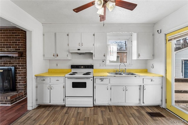 kitchen featuring visible vents, white range with electric cooktop, a sink, under cabinet range hood, and white cabinetry