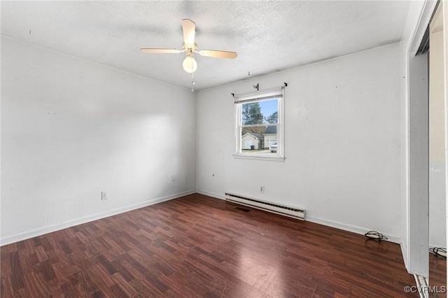 empty room with a textured ceiling, wood finished floors, baseboards, baseboard heating, and ceiling fan