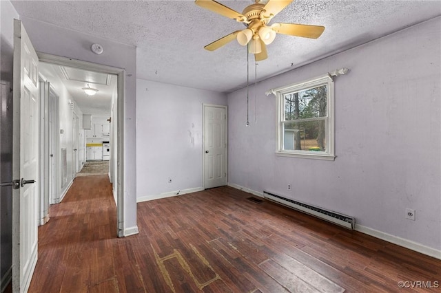 unfurnished bedroom with wood finished floors, baseboards, a baseboard radiator, attic access, and a textured ceiling