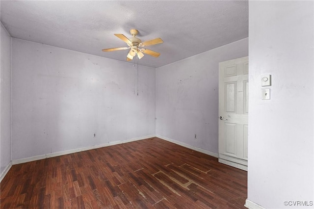 spare room featuring wood finished floors, a ceiling fan, baseboards, and a textured ceiling