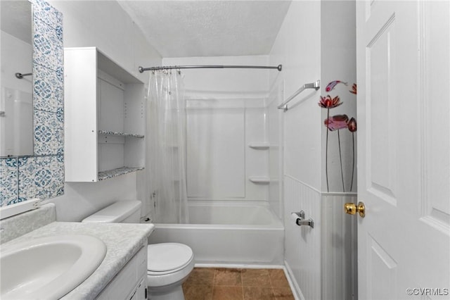 full bath featuring vanity, tile patterned flooring, shower / bath combo with shower curtain, a textured ceiling, and toilet