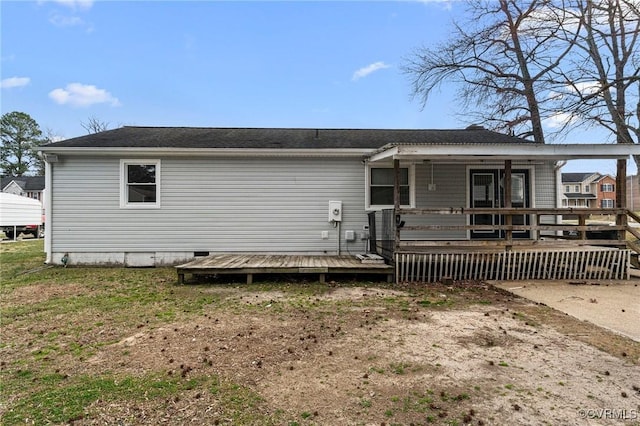 back of property with a wooden deck