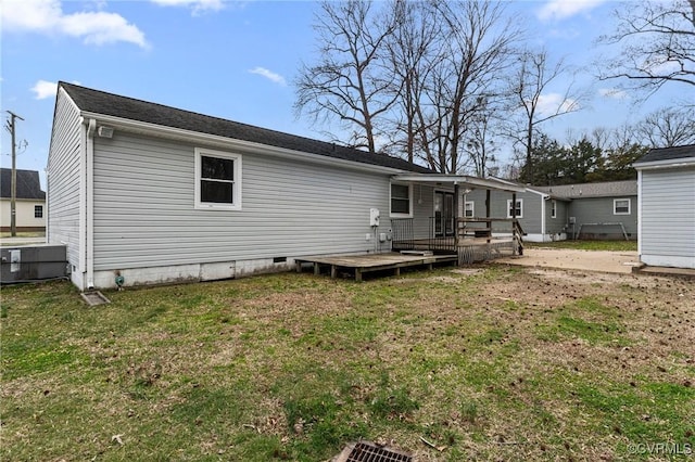 rear view of house featuring a yard and a deck