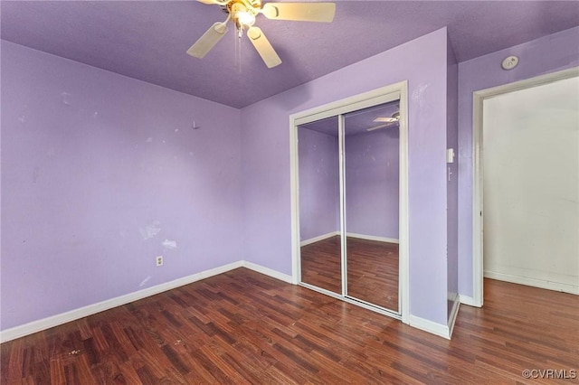 unfurnished bedroom with a closet, ceiling fan, baseboards, and wood finished floors