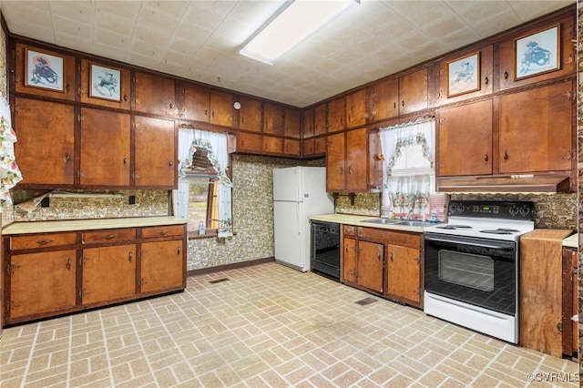 kitchen featuring freestanding refrigerator, range with electric cooktop, light countertops, black dishwasher, and under cabinet range hood