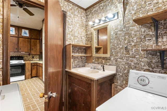 bathroom featuring ornamental molding, washer / dryer, brick floor, vanity, and a ceiling fan