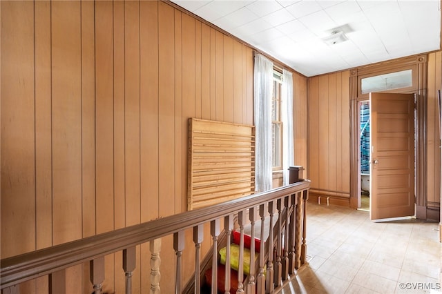 hall with an upstairs landing and wooden walls