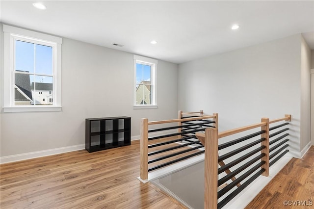 stairway featuring visible vents, recessed lighting, baseboards, and wood finished floors