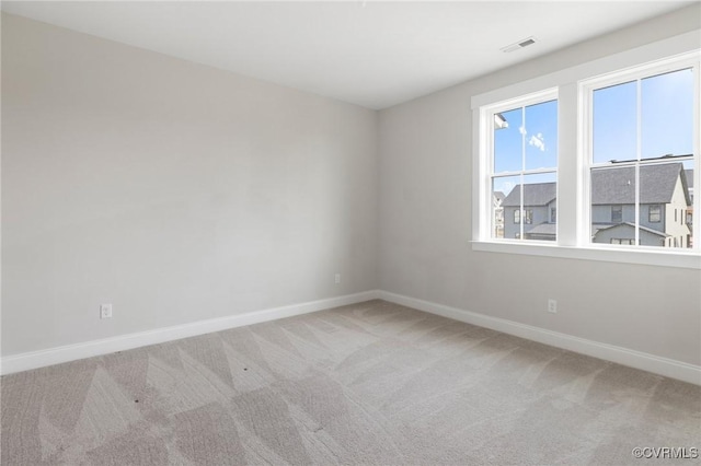 unfurnished room featuring visible vents, baseboards, and carpet flooring