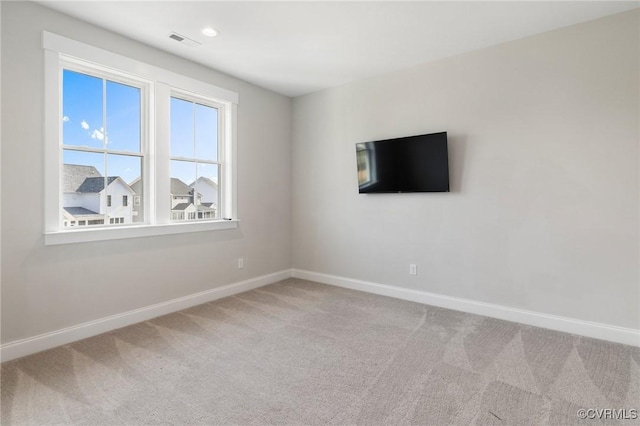 carpeted spare room with recessed lighting, visible vents, and baseboards