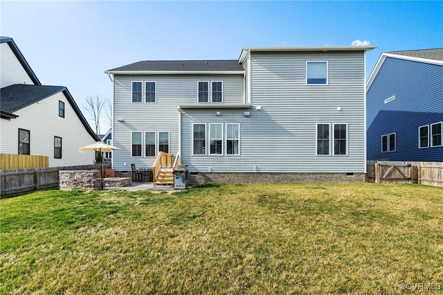 rear view of house featuring a lawn, a fenced backyard, and crawl space