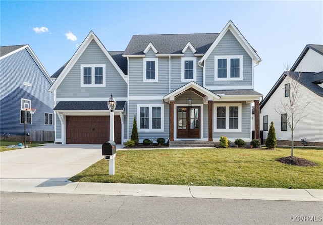 view of front of house featuring an attached garage, a front yard, french doors, and concrete driveway