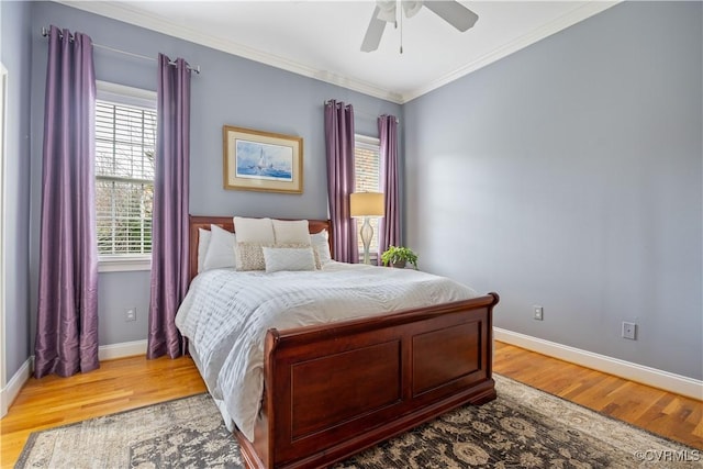 bedroom featuring multiple windows, light wood-type flooring, and ornamental molding