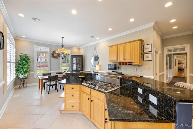 kitchen with light tile patterned floors, a notable chandelier, ornamental molding, and light brown cabinets