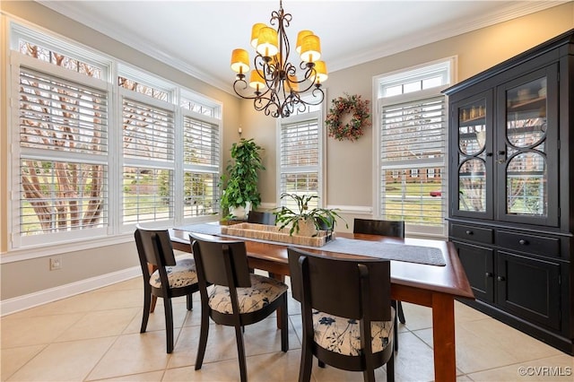 dining space with light tile patterned floors, a healthy amount of sunlight, a chandelier, and crown molding