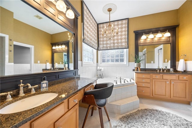 full bath featuring a sink, visible vents, a bath, and tile patterned floors