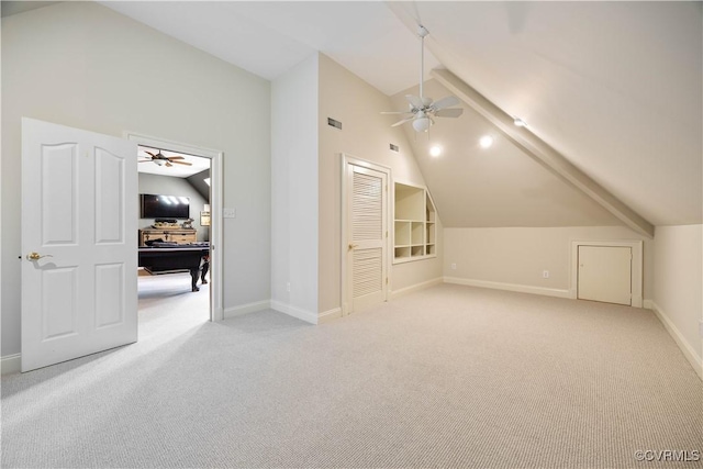 additional living space featuring lofted ceiling, a ceiling fan, and light colored carpet