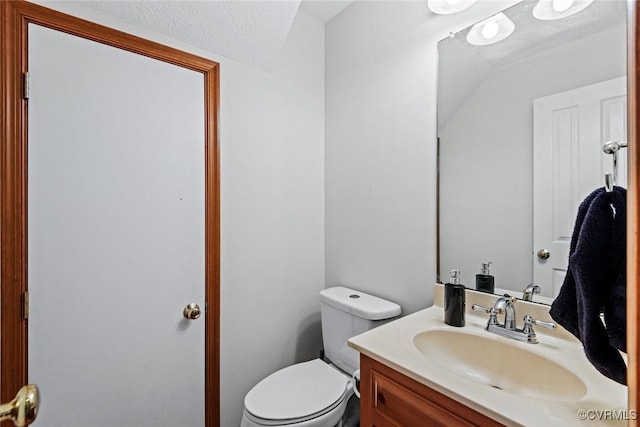 half bathroom with toilet and vanity