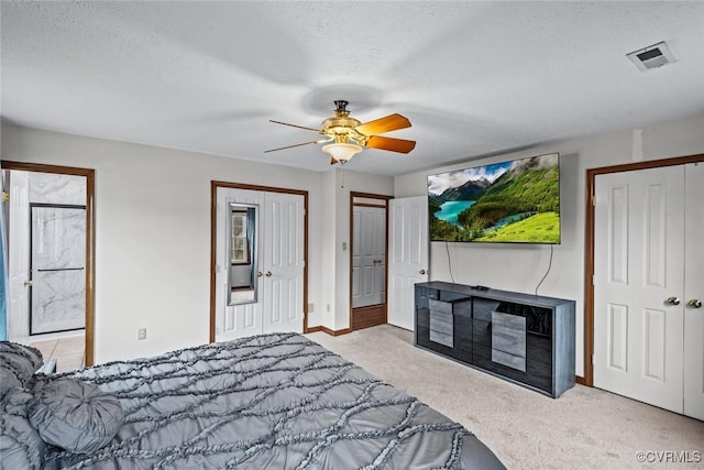 bedroom with visible vents, a ceiling fan, a textured ceiling, carpet floors, and baseboards