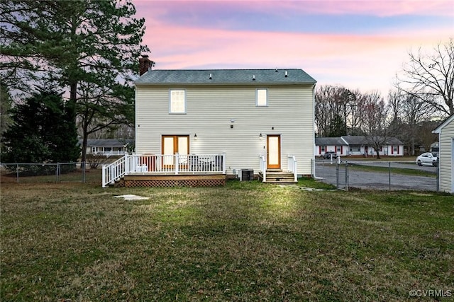 rear view of property with fence, central air condition unit, a lawn, a chimney, and a deck