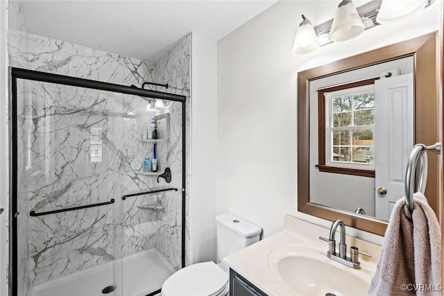 bathroom with a marble finish shower, toilet, and vanity