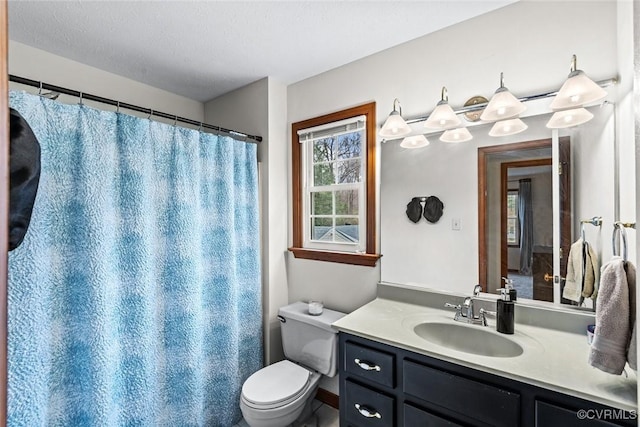 bathroom with curtained shower, toilet, and vanity