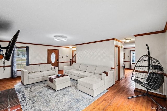 living room featuring wood finished floors and crown molding