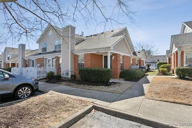 view of side of home featuring brick siding and a residential view