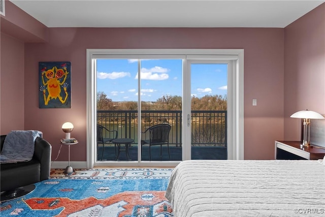 bedroom featuring visible vents, baseboards, and access to outside