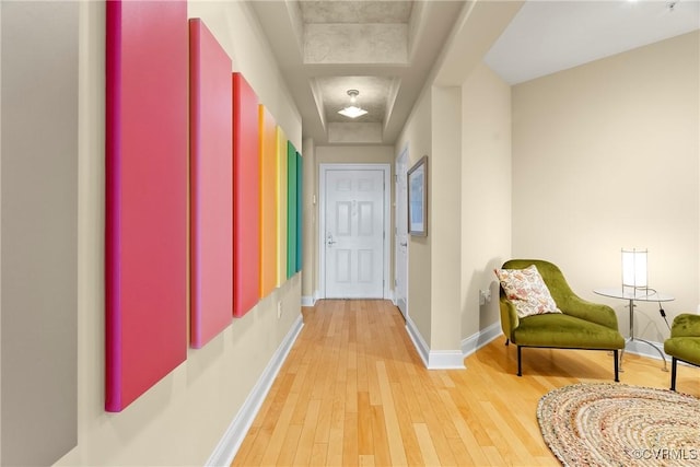 hallway featuring baseboards and light wood-type flooring