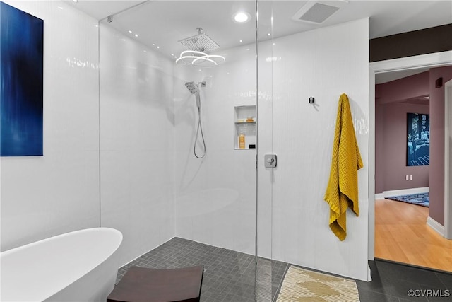 full bath featuring visible vents, recessed lighting, a freestanding bath, and walk in shower