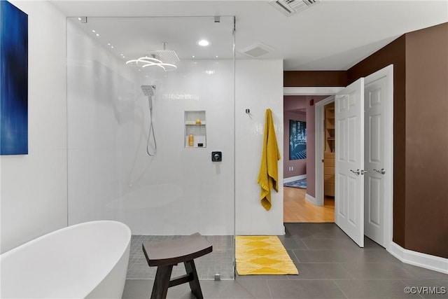 full bathroom featuring visible vents, a walk in shower, baseboards, a freestanding bath, and recessed lighting