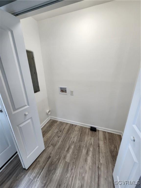 laundry room featuring washer hookup, laundry area, wood finished floors, and baseboards