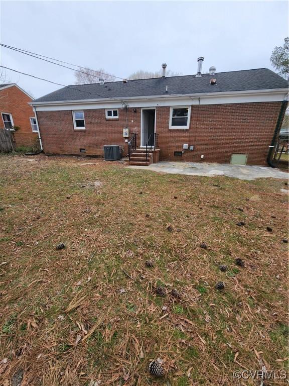 rear view of property featuring crawl space, a yard, entry steps, and a patio