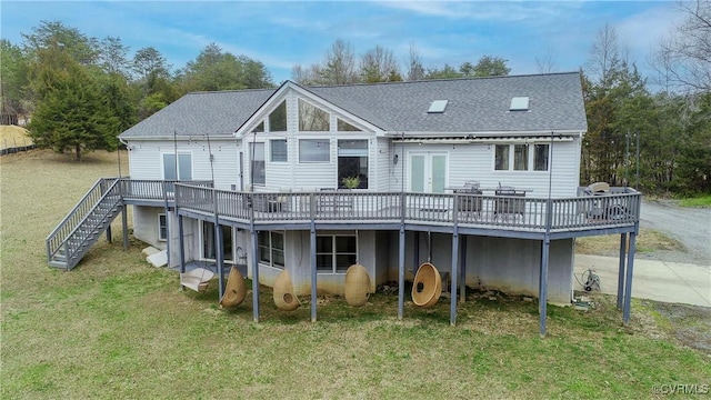 rear view of house with stairway, driveway, a yard, a shingled roof, and a deck