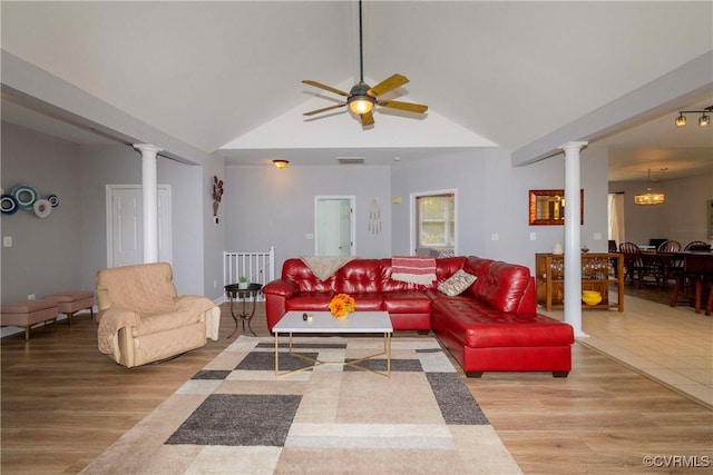 living area featuring wood finished floors, ornate columns, and ceiling fan