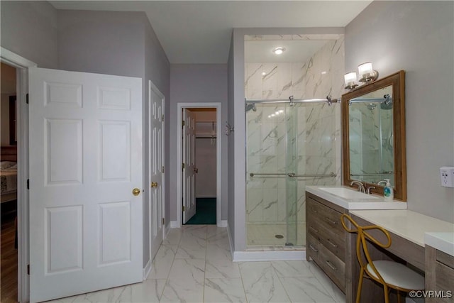 full bathroom featuring vanity, baseboards, marble finish floor, and a marble finish shower