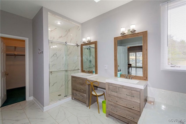 bathroom featuring marble finish floor, a marble finish shower, and a sink